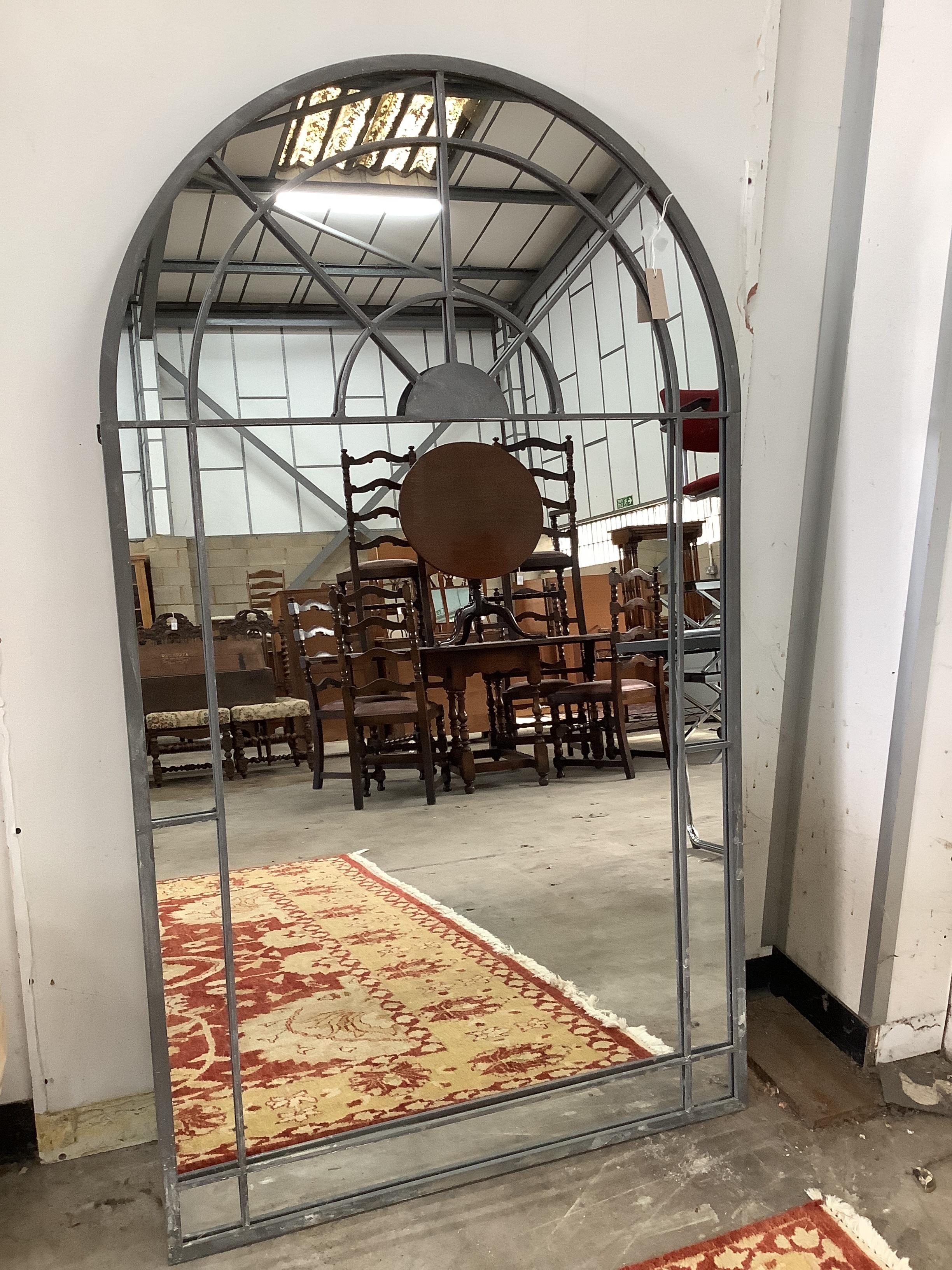 A large industrial style metal mounted arched garden window frame wall mirror, width 90cm, height 155cm